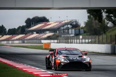 Front view of the SWR Performance Aston Martin Vantage GT4 race car approaching a circuit bridge