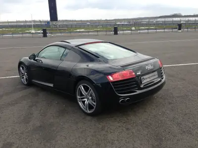 Black Audi R8 parked in the pit garage