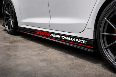Close-up of the SWR Performance branded decal on the race car livery