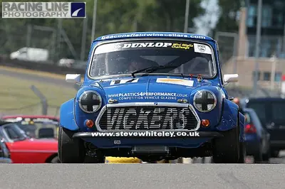 Front view of a blue racing Mini on circuit
