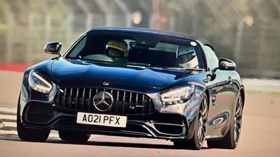 Stephen Whiteley coaching a driver in a Mercedes-AMG GT, yellow helmet