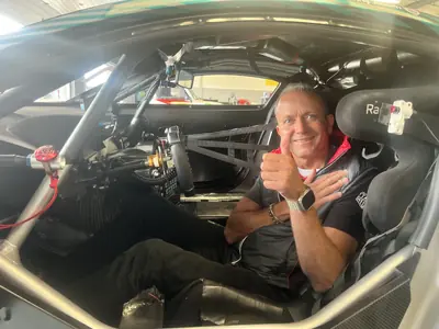 Stephen Whiteley giving a thumbs up from the cockpit of a race car, helmet on, ready for a session