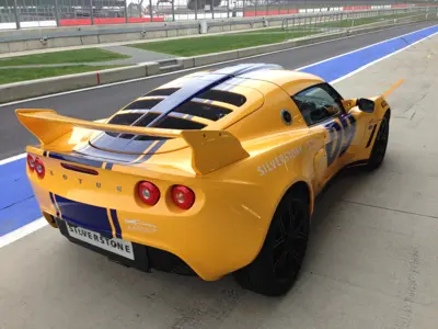 Yellow and blue liveried Lotus Exige at Silverstone pit lane