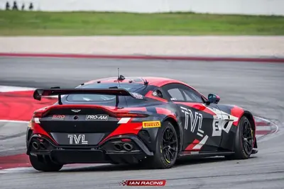 Rear angle of the SWR Performance Aston Martin Vantage GT4 race car on track