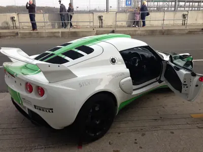 Green and white liveried Lotus Exige with door open at Silverstone
